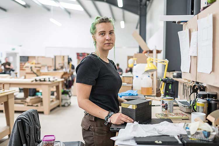 50 week student Laura at her bench at robinson house studio